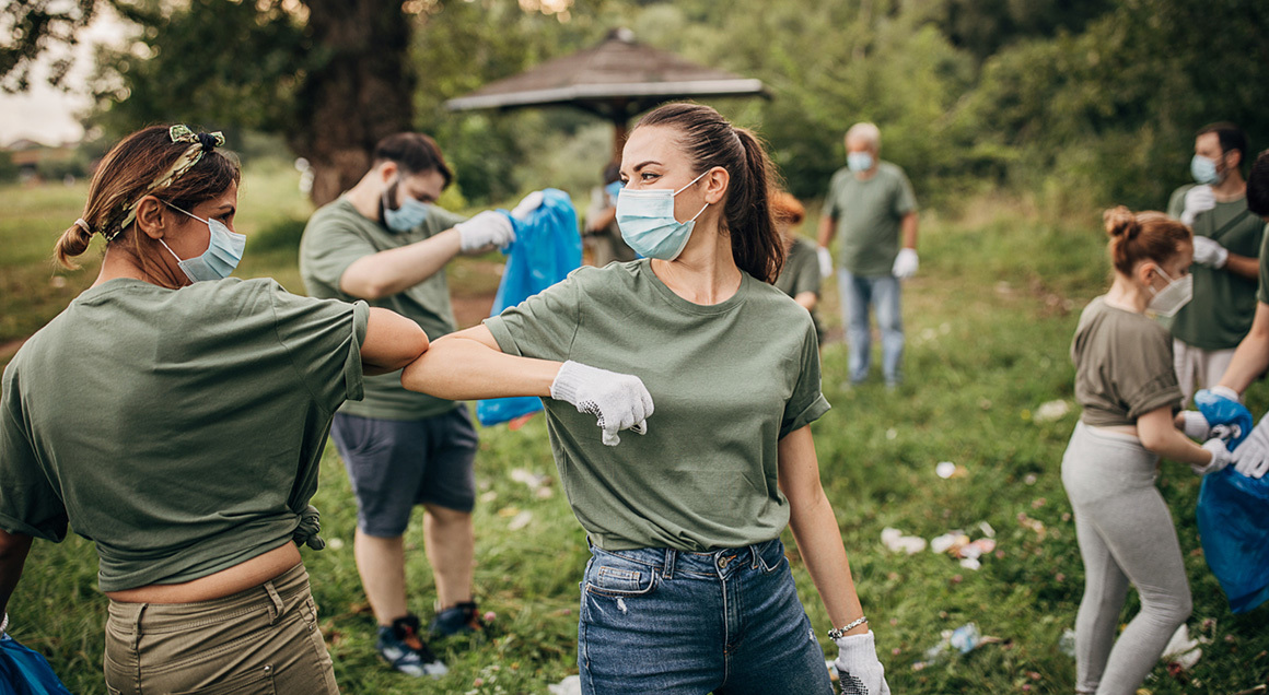 Group with masks picking up trash