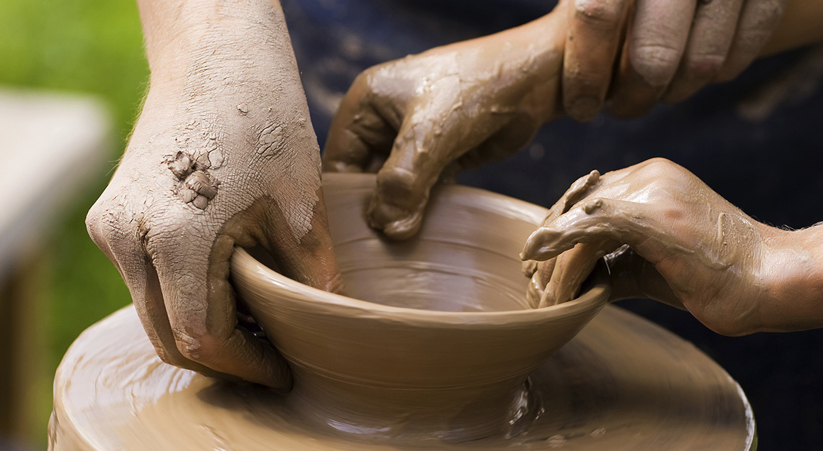 Hands working clay pottery 72px