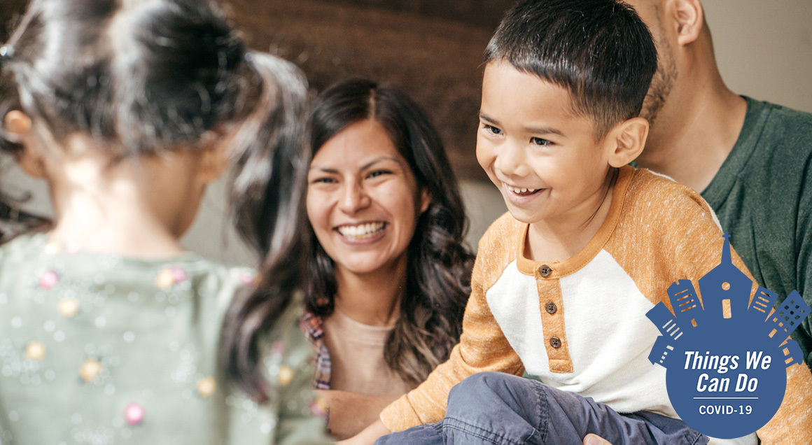 Hispanic family 1160x636 with covid badge
