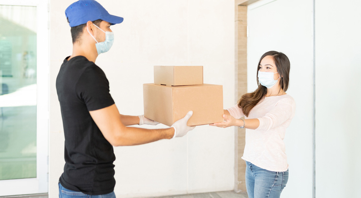Stock delivering packages wearing masks
