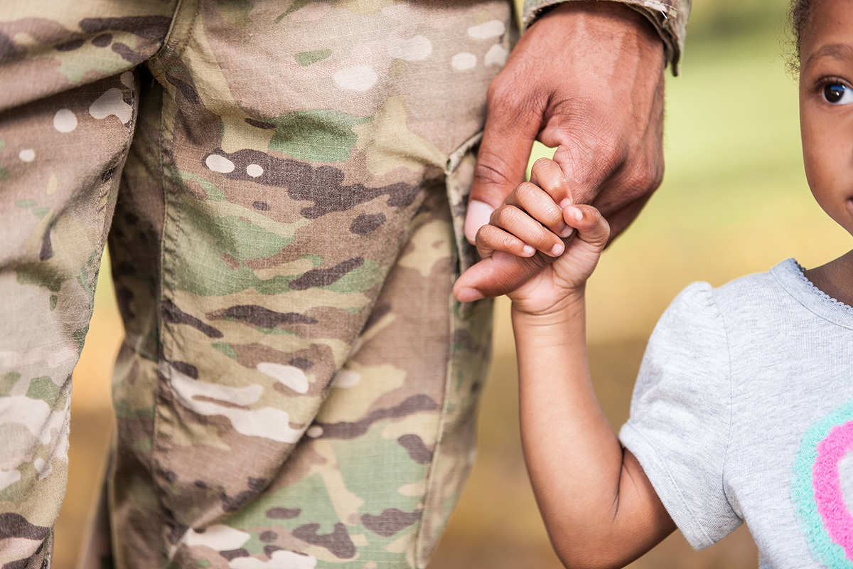 Stock girl holding soldiers hand