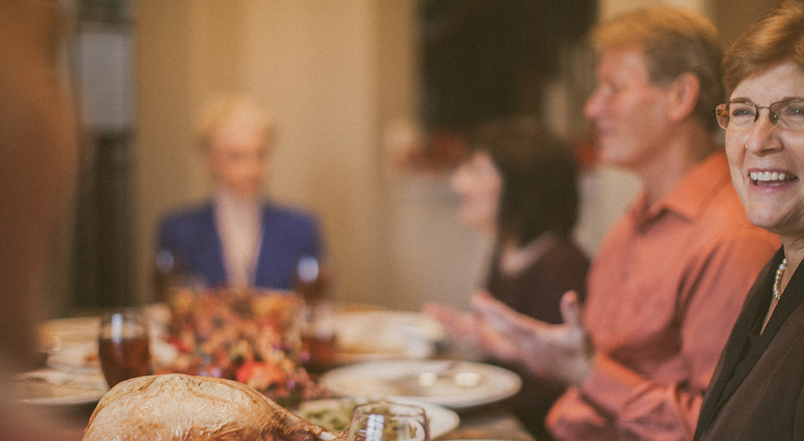 Stock group gathered around table 1160x636
