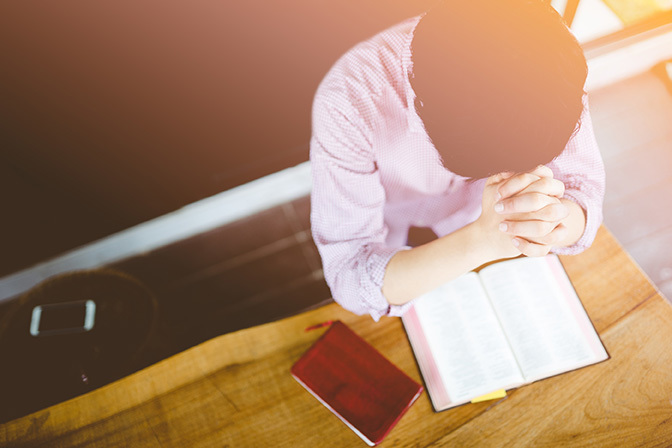Stock overhead view of man praying