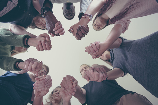 Stock people holding hands in a circle