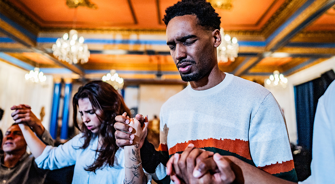 I S Young African Man Praying With Group